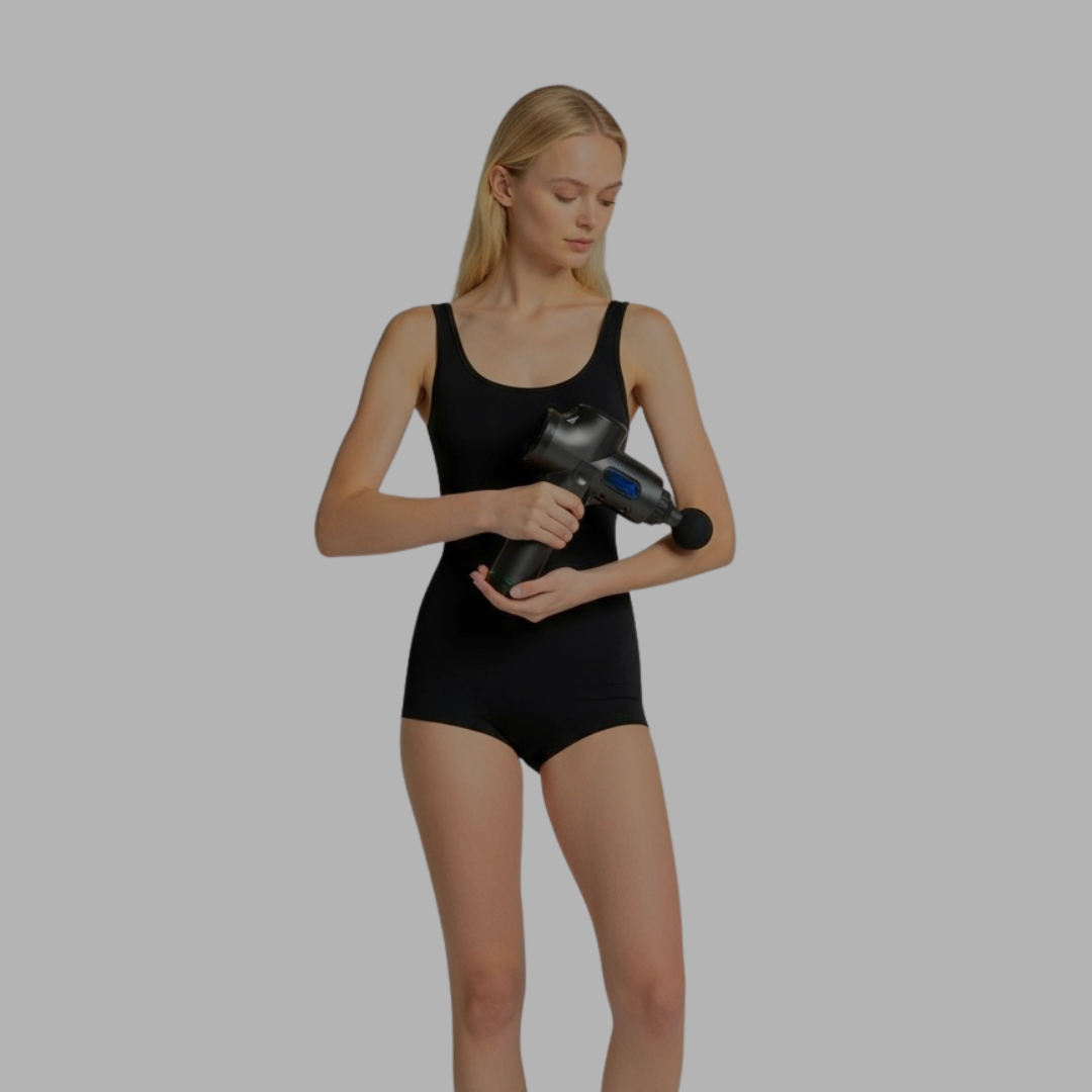 Woman in a black swimsuit holding a black and blue massage device on a gray background